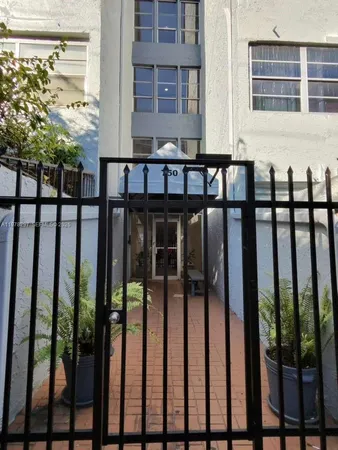 a view of a brick house with large windows