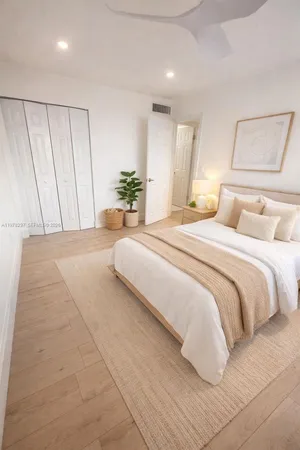 a bedroom with a large bed and a chandelier