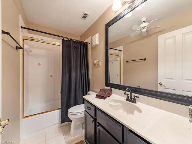 a bathroom with a sink toilet double vanity and shower