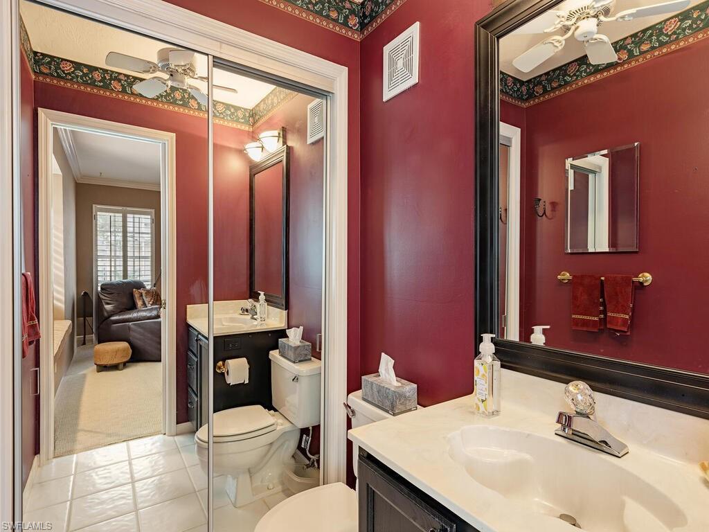2839 Aintree Lane, Unit B202 Naples, FL 34112 - Photo 17 of 31 a bathroom with a sink a toilet a mirror and shower