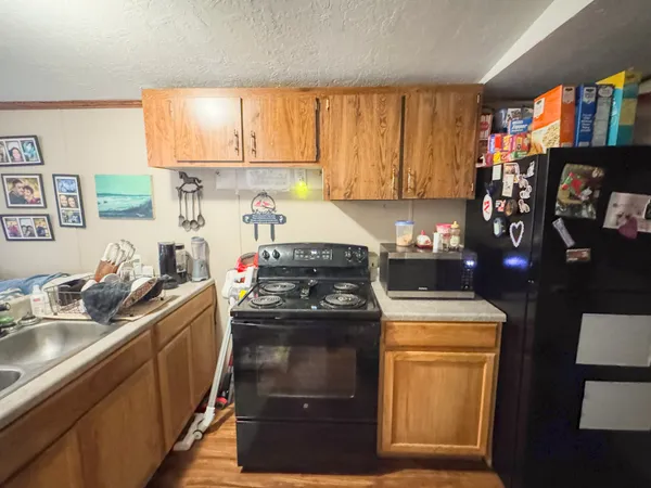 a kitchen with stainless steel appliances granite countertop a sink stove and cabinets