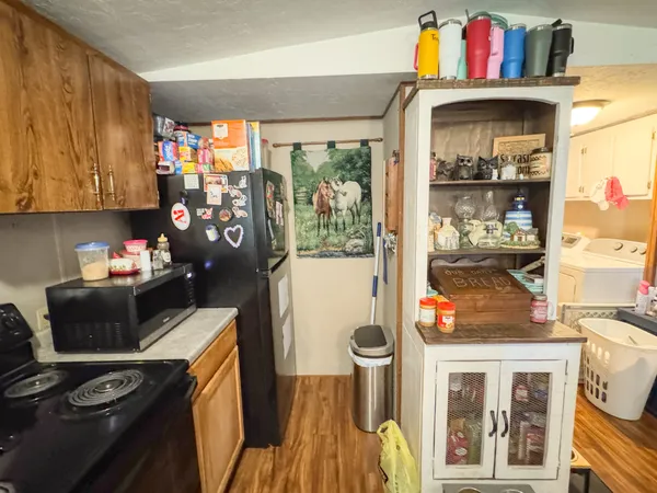 a kitchen with a refrigerator and a stove