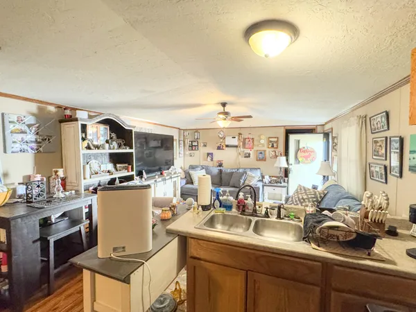 a kitchen with a sink appliances and cabinets