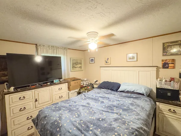 a bedroom with a bed and a flat screen tv