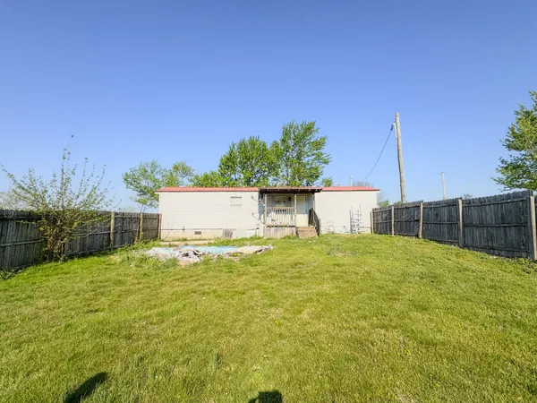 a house with green field in front of it