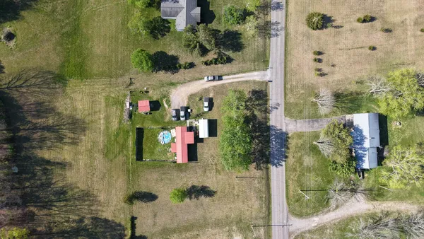 aerial view of a house with outdoor seating