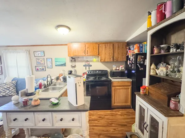 a kitchen with stainless steel appliances granite countertop a stove a sink and a refrigerator
