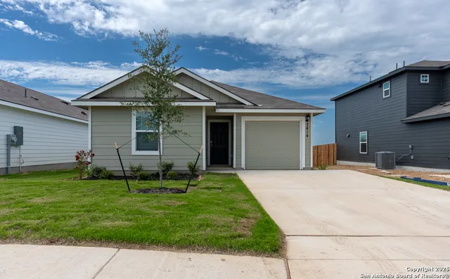 a backyard of a house with table and chairs