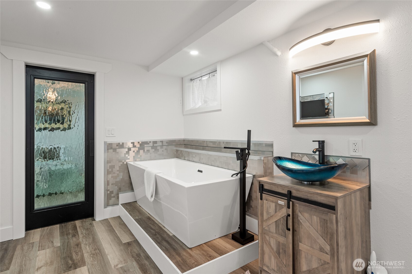 3161 Locust Avenue Bellingham, WA 98225 - Photo 24 of 40 a view of a bathroom with a sink and mirror