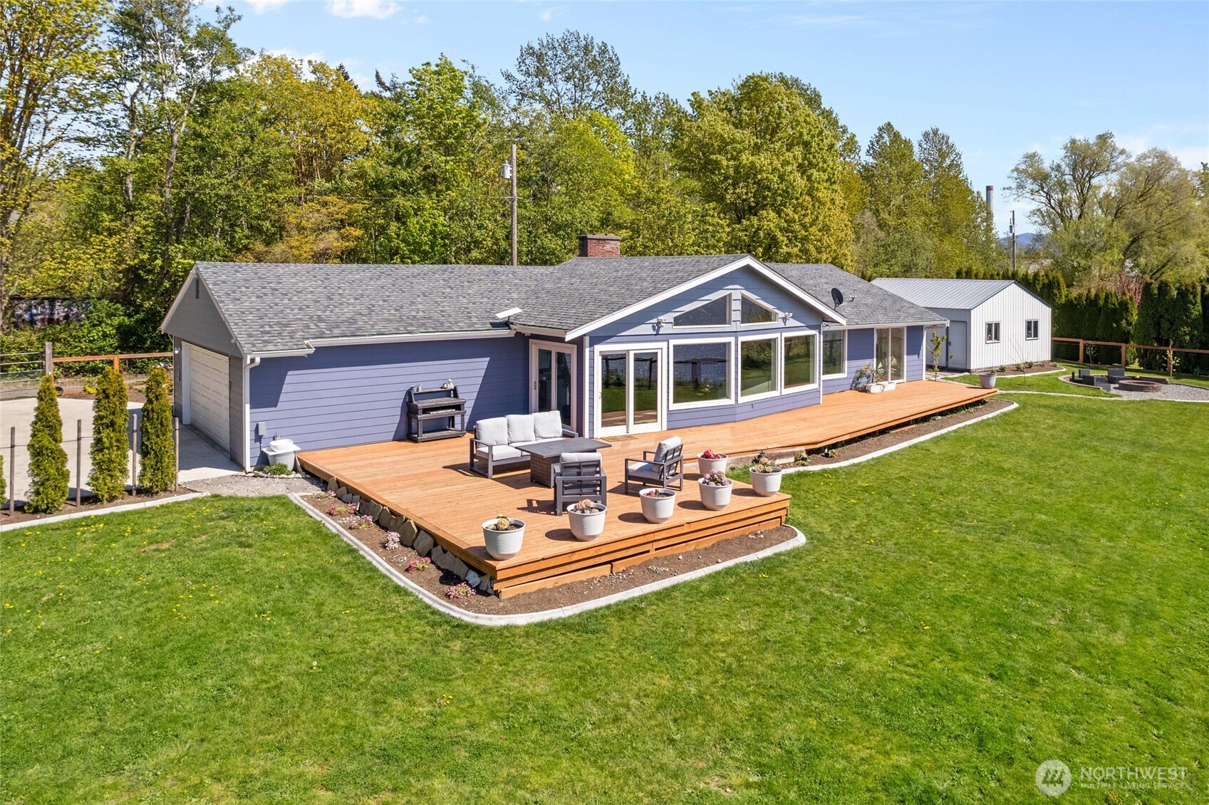 3161 Locust Avenue Bellingham, WA 98225 - Photo 3 of 40 a front view of a house with a garden and trees