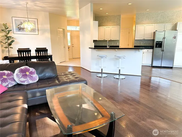 a kitchen with stainless steel appliances a stove a sink and a refrigerator
