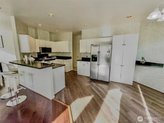 a kitchen with a sink and large window