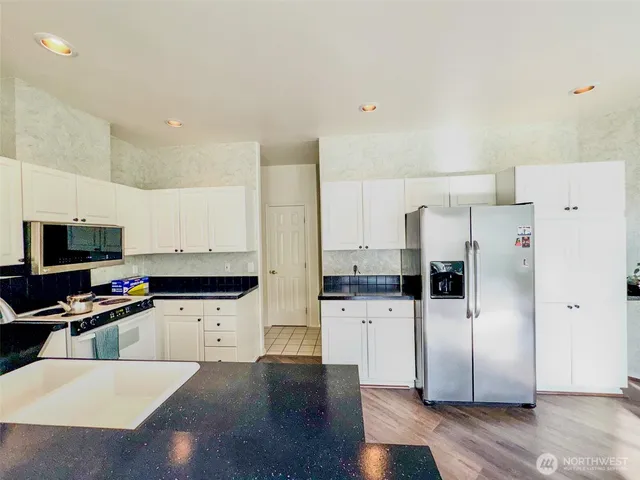 a living room with fireplace furniture and a large window
