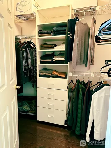 a view of a chair and table in backyard of the house