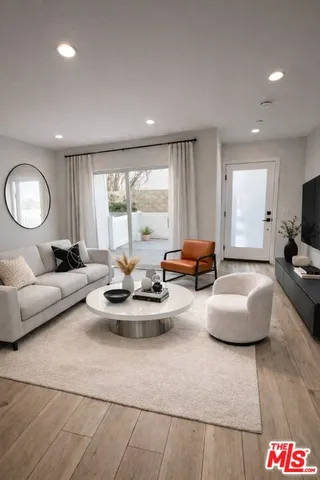 a bedroom with a large bed and a view of kitchen