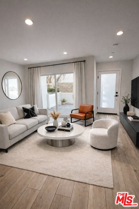 121 East 223rd Street, Unit 4 Carson, CA 90745 - Photo 6 of 14 a living room with furniture and a large window