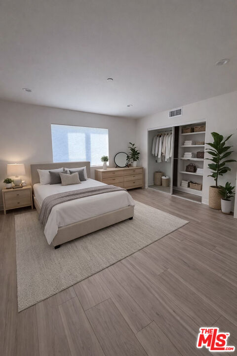 121 East 223rd Street, Unit 4 Carson, CA 90745 - Photo 7 of 14 a bedroom with a large bed and a view of kitchen