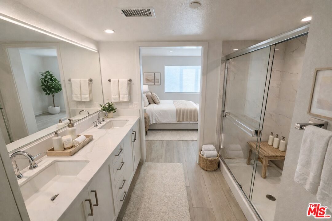 121 East 223rd Street, Unit 4 Carson, CA 90745 - Photo 8 of 14 a spacious bathroom with double vanity sink and a mirror
