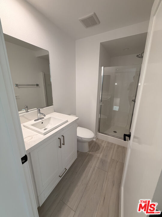 121 East 223rd Street, Unit 4 Carson, CA 90745 - Photo 10 of 14 a bathroom with a double vanity sink toilet and shower