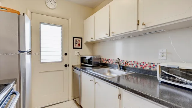 a kitchen with stainless steel appliances granite countertop a sink dishwasher stove and refrigerator