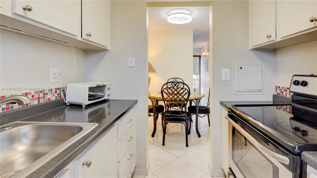 a kitchen with stainless steel appliances granite countertop a sink and a stove