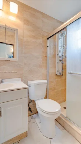a bathroom with a toilet sink and a shower