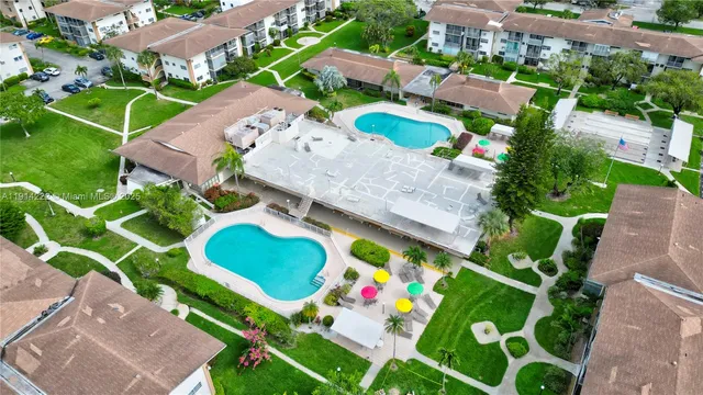 an aerial view of a house a yard and outdoor seating