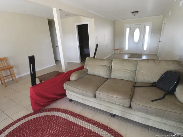 a view of a bedroom with a bed and a rug