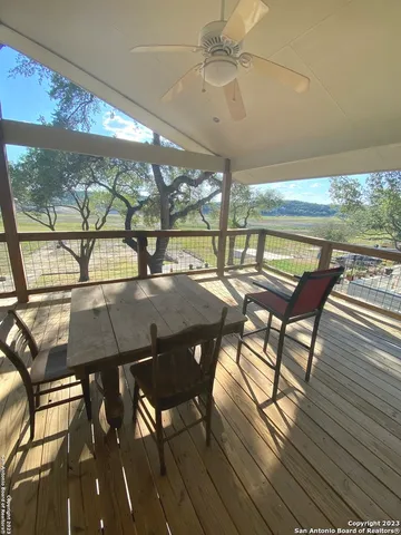a view of a patio with table and chairs