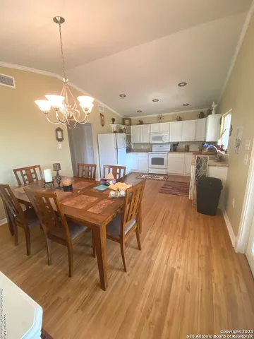 a living room with dining room and wooden floor
