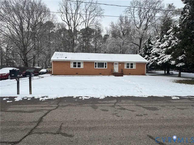 a view of a house with snow on the road