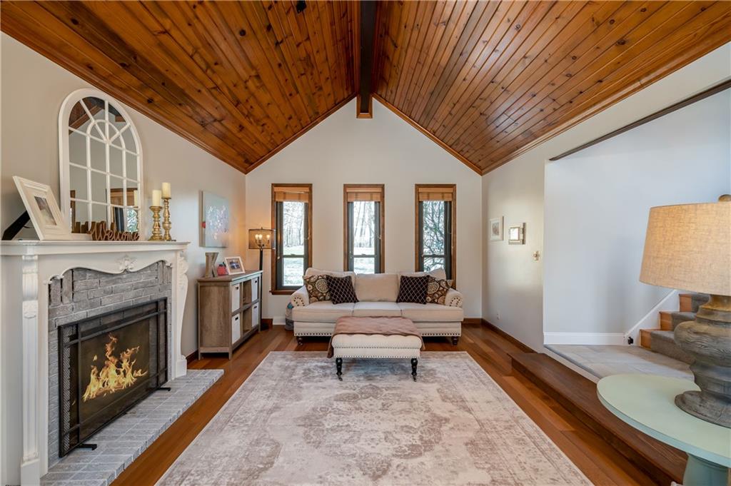 2020 Kentucky Lane Rochester, PA 15074 - Photo 6 of 25 The living room features cathedral ceilings with a wood burning fireplace.