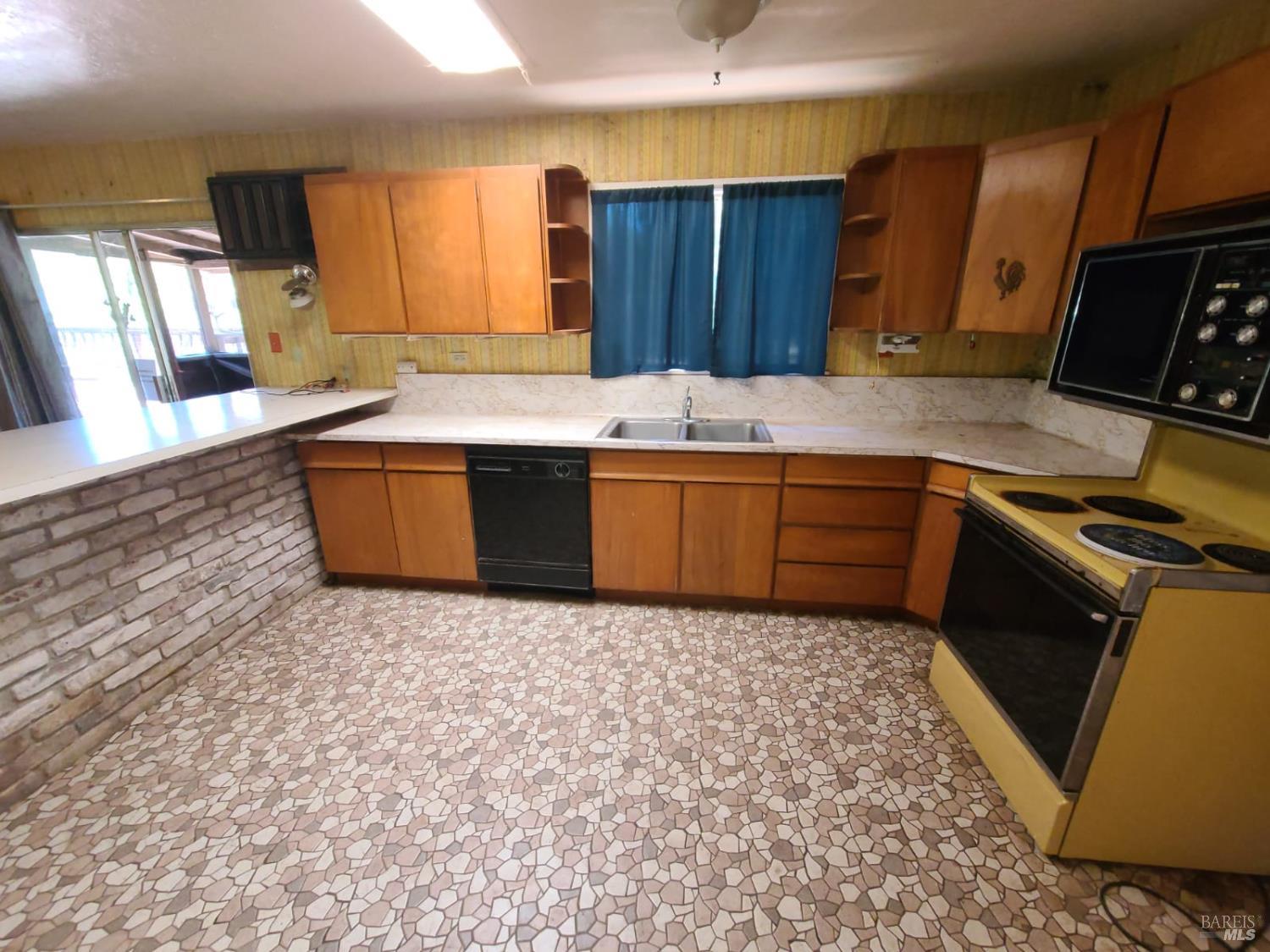 3620 Eel River Ranch Road Covelo, CA 95428 - Photo 12 of 27 a kitchen with stainless steel appliances granite countertop a sink stove and microwave