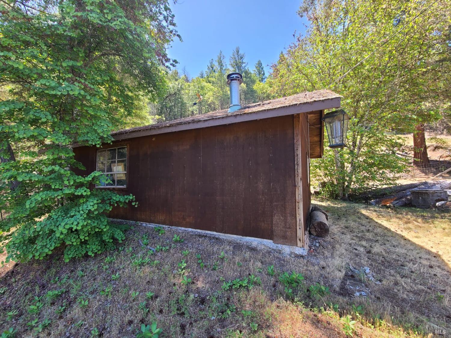 3620 Eel River Ranch Road Covelo, CA 95428 - Photo 23 of 27 a backyard of a house with lots of green space