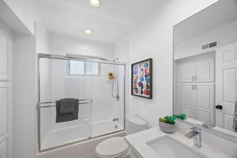 a bathroom with a sink toilet and shower