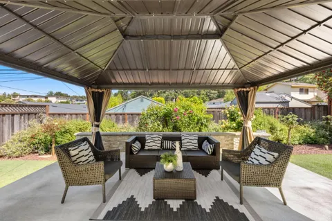 a balcony with furniture and garden view