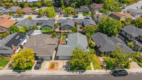 an aerial view of residential houses with outdoor space