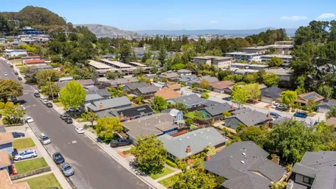 an aerial view of residential houses with outdoor space