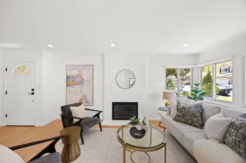 a living room with furniture a rug and a fireplace