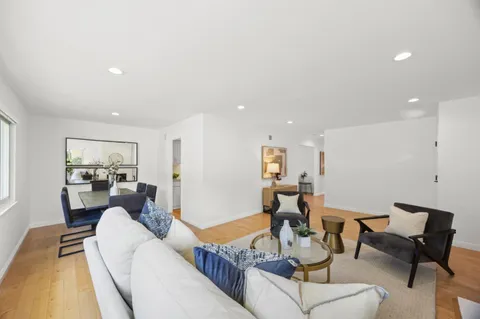 a living room with furniture and kitchen view