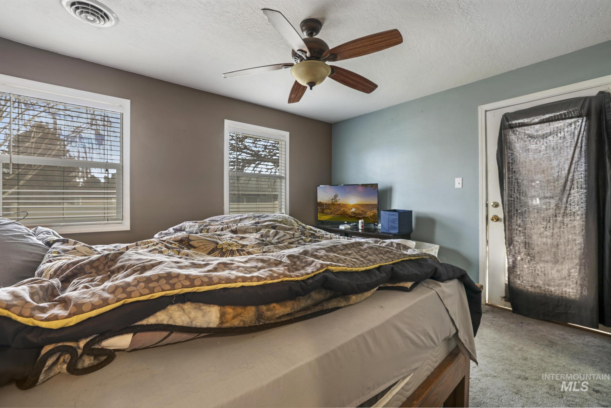 721 Beta Circle Twin Falls, ID 83301 - Photo 18 of 28 Carpeted bedroom with a textured ceiling and ceiling fan