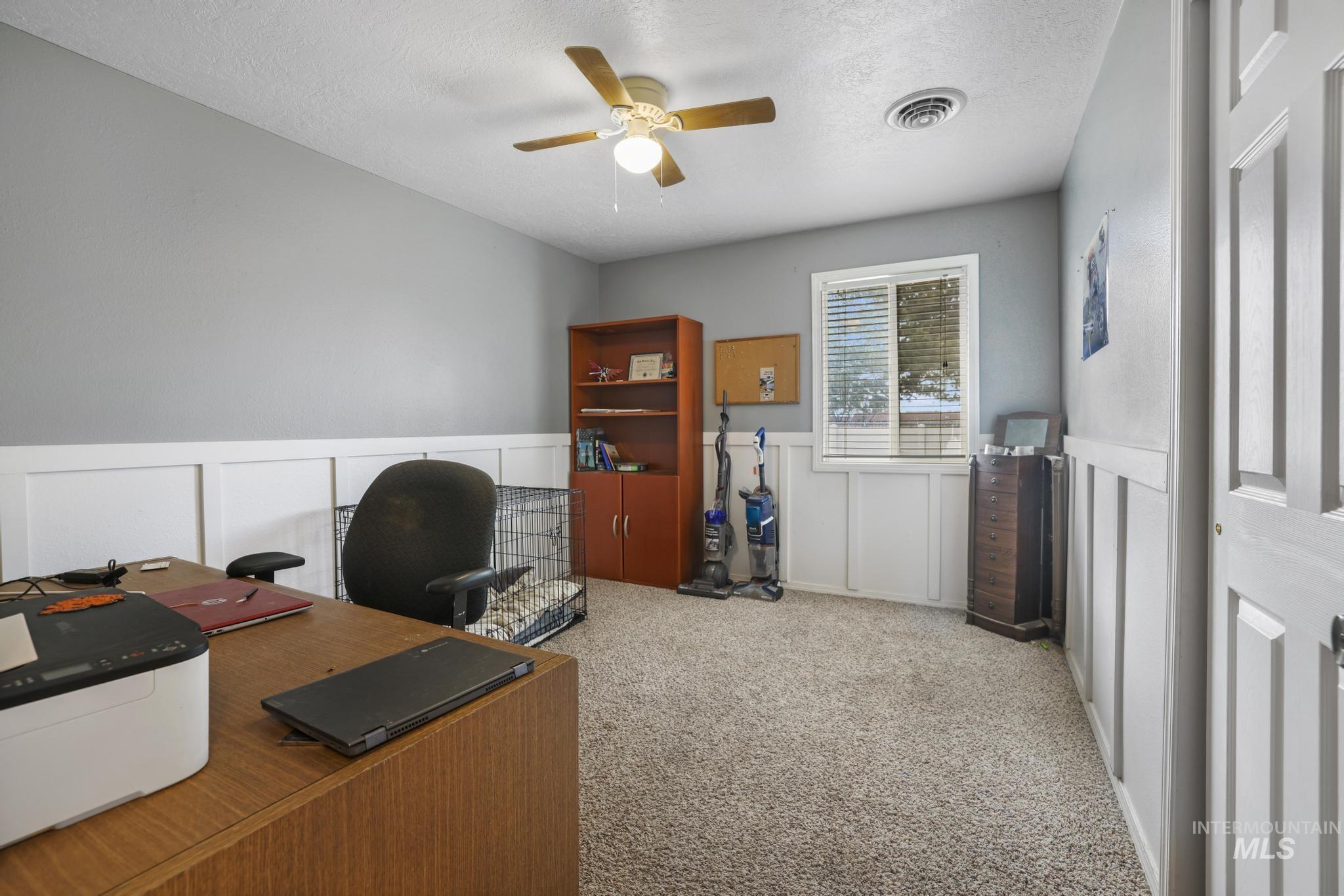 721 Beta Circle Twin Falls, ID 83301 - Photo 20 of 28 Office space with a decorative wall, light colored carpet, a wainscoted wall, and ceiling fan