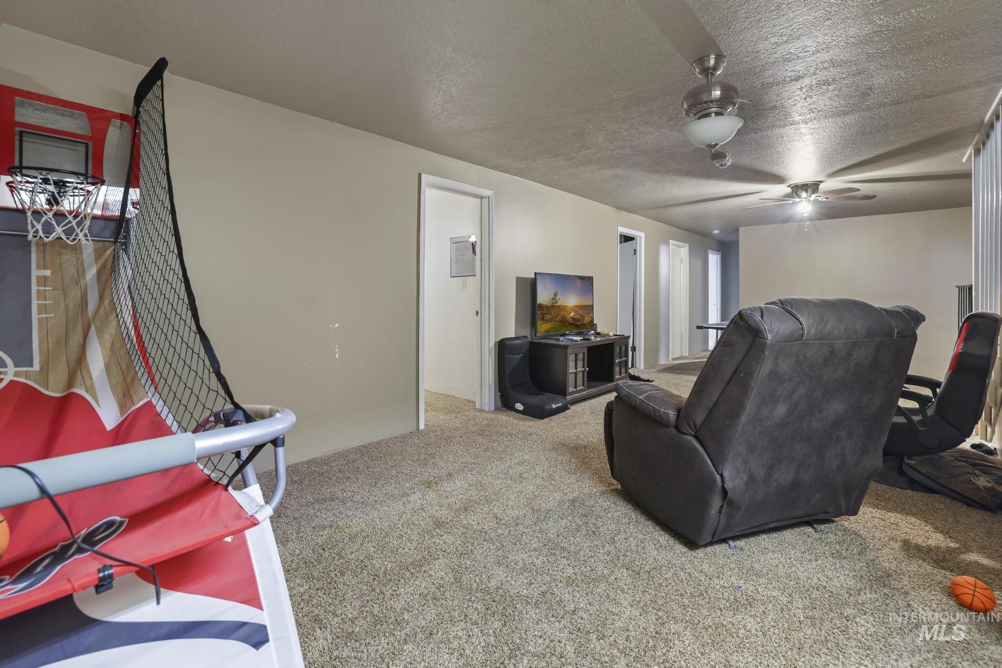 721 Beta Circle Twin Falls, ID 83301 - Photo 25 of 28 Home theater featuring carpet and a textured ceiling