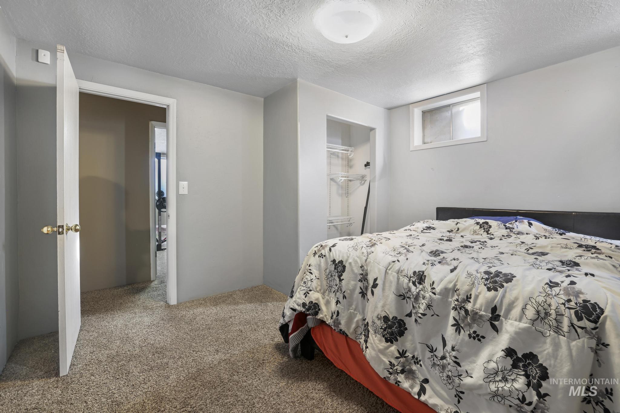 721 Beta Circle Twin Falls, ID 83301 - Photo 27 of 28 Bedroom featuring a textured ceiling and carpet