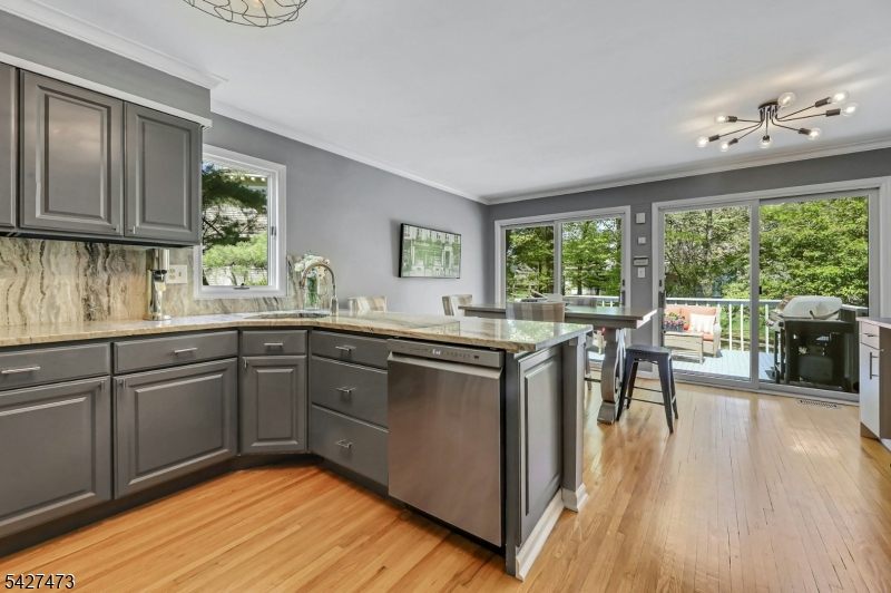 100 Easedale Road, Unit 100 Wayne, NJ 07470 - Photo 15 of 43 a kitchen with stainless steel appliances granite countertop wooden floors and sink