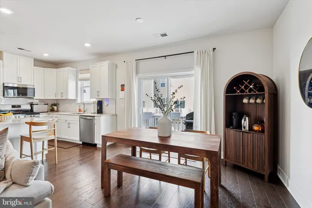 a kitchen with white cabinets and refrigerator