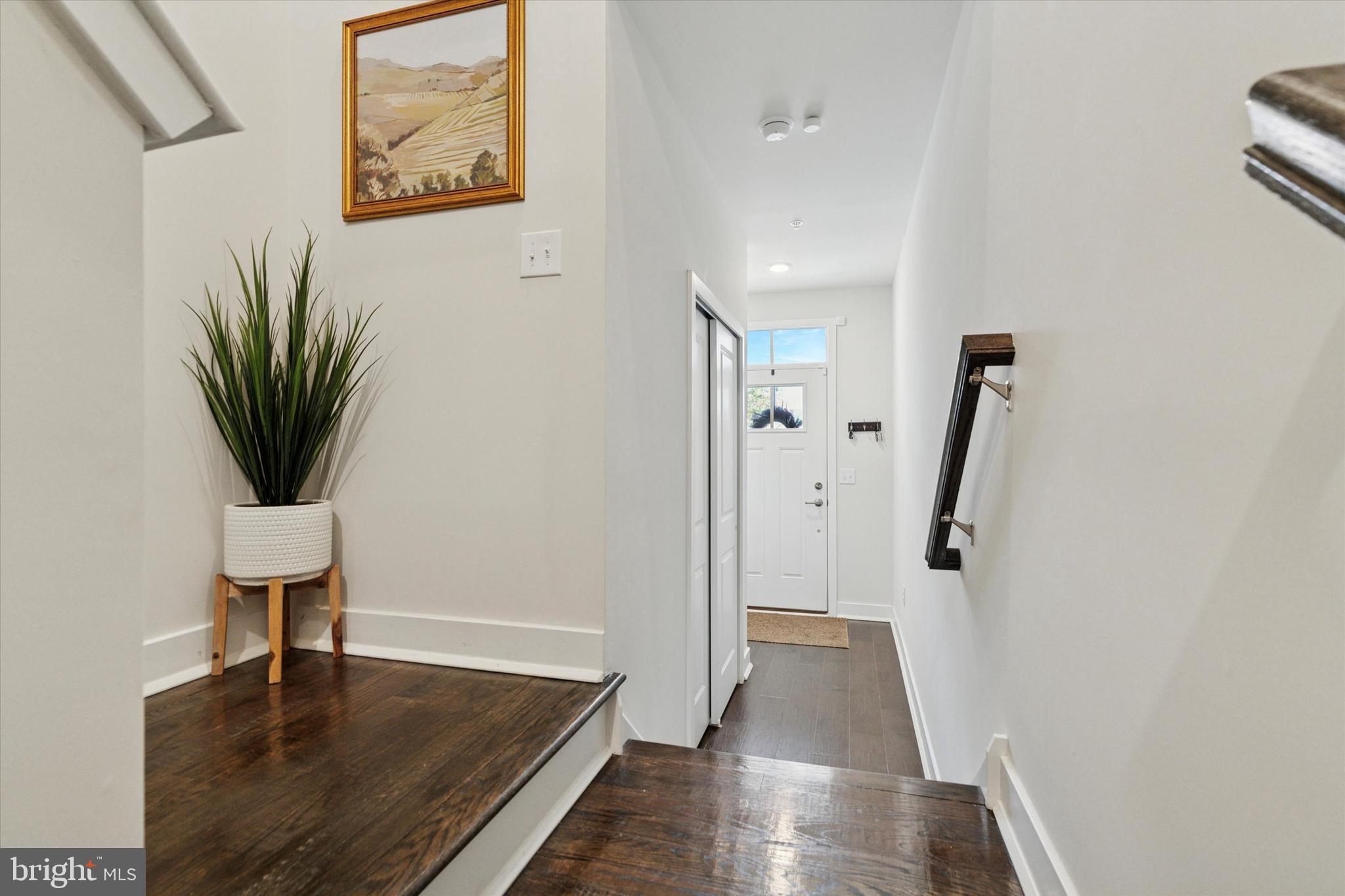 784 Ore Street Phoenixville, PA 19460 - Photo 3 of 30 a view of a hallway with wooden floor and a potted plant