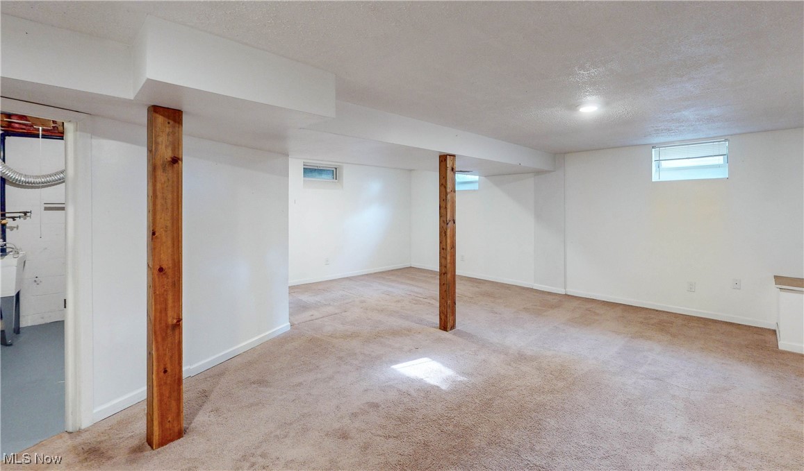 3491 Kent Road Stow, OH 44224 - Photo 26 of 40 Basement featuring a textured ceiling, windows and carpet
