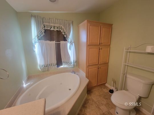 747 North Charles Street Ridgecrest, CA 93555 - Photo 9 of 23 a bathroom with a tub toilet and sink