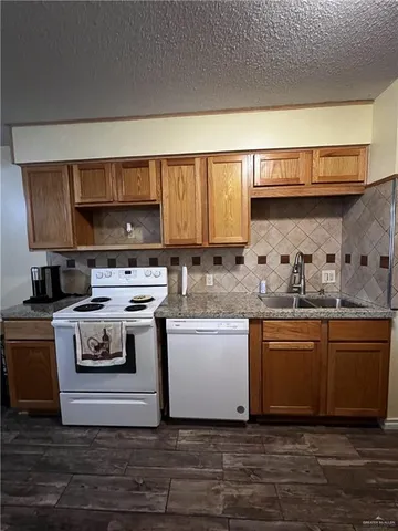 a kitchen with stainless steel appliances granite countertop a stove and a sink